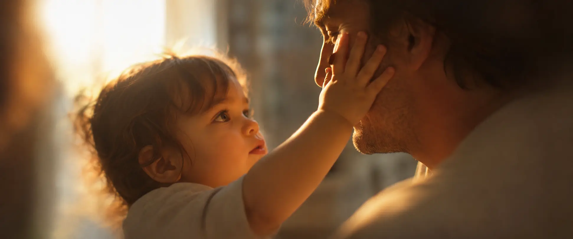 A toddler touching a parent's face, illustrating why we cant remember being babies